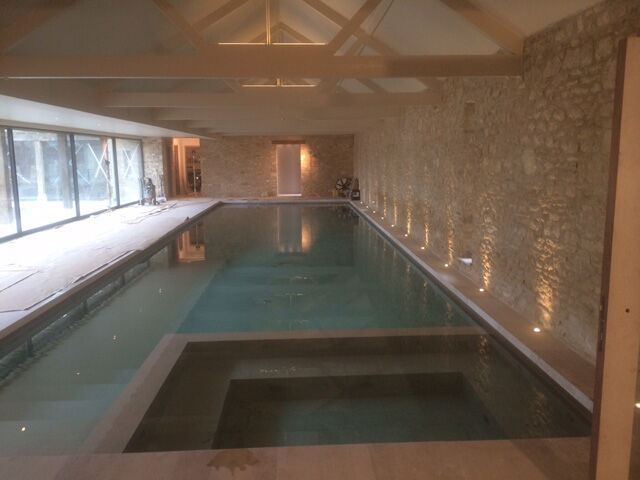 Indoor swimming pool with scene set lighting
